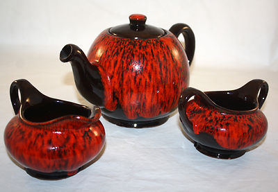 MID CENTURY RETRO CANUCK POTTERY ORANGE FLAME TEA SET TEAPOT SUGAR AND CREAMER-image