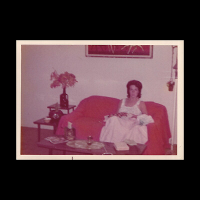 Old Vintage Photo BLURRY/FUZZY WOMAN SITTING ON ORANGE COUCH MID CENTURY MODERN-image