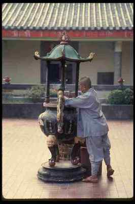 057035 Female Monk Cleaning Joss Sticks Siong Lim Temple Complex A4 Photo Print-image
