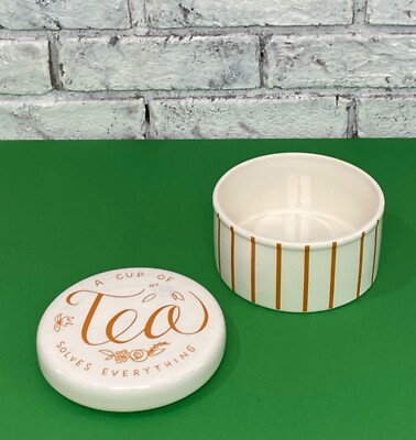 Creative Co-op A Cup Of Tea Solves Everything 5.5in Tea Bag Ceramic Canister-image