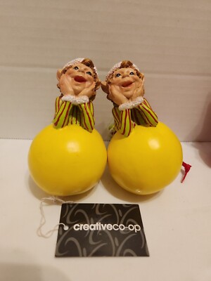  2 Green Elf Figure Sitting on Yellow Ball Creative Co-op-image